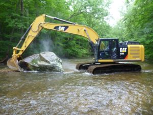 Enormous boulder w track excavator